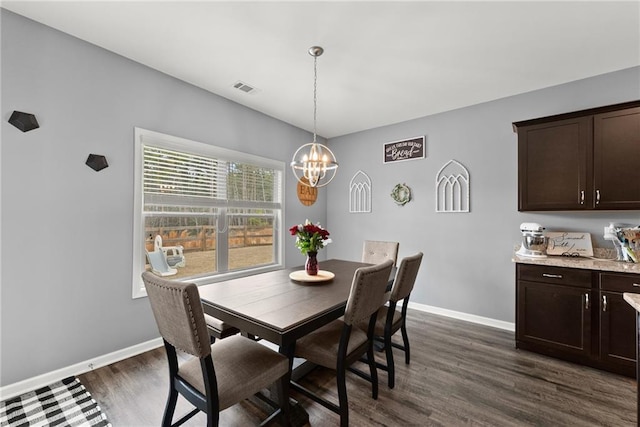dining room with visible vents, baseboards, dark wood-type flooring, and a chandelier