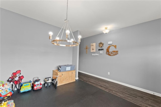 dining room featuring baseboards and a notable chandelier