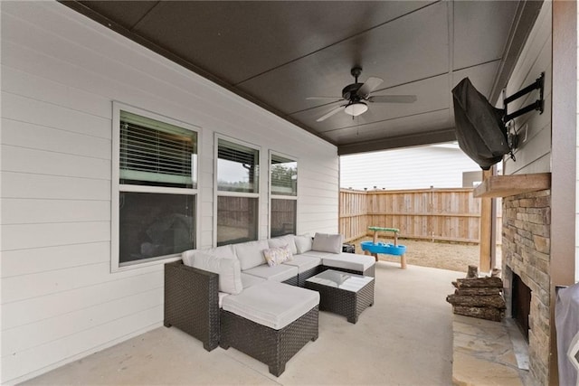 view of patio / terrace featuring fence, ceiling fan, and an outdoor living space