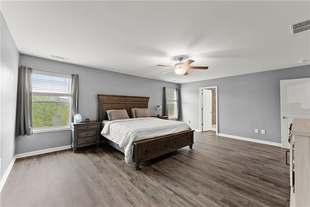 bedroom featuring dark wood-style flooring, baseboards, and visible vents