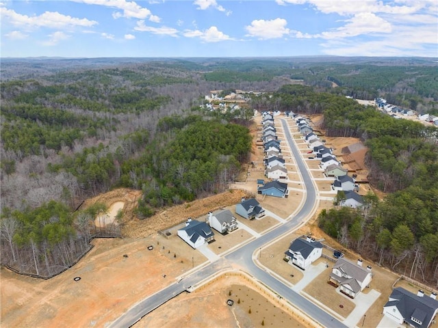 birds eye view of property featuring a residential view and a wooded view