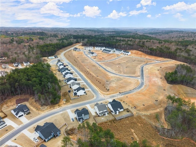 birds eye view of property with a wooded view