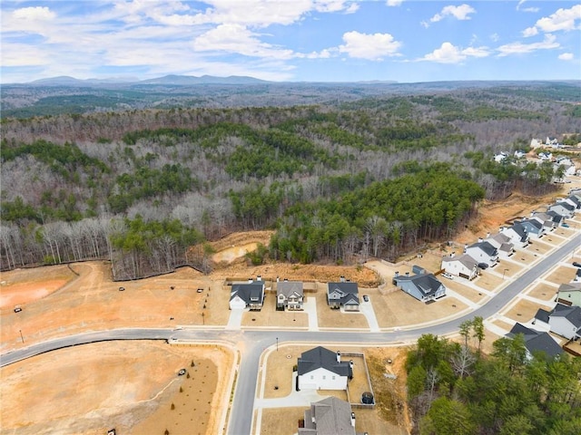 bird's eye view with a wooded view and a mountain view