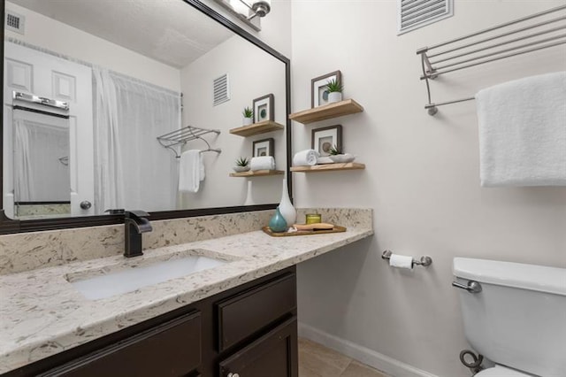 3701 Essex Ave Unit 2, Atlanta, GA 30339 - bathroom featuring toilet, vanity, baseboards, and tile patterned flooring