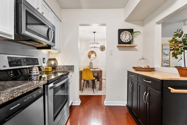 3701 Essex Ave Unit 2, Atlanta, GA 30339 - kitchen featuring appliances with stainless steel finishes, dark wood finished floors, dark cabinetry, baseboards, and dark stone counters