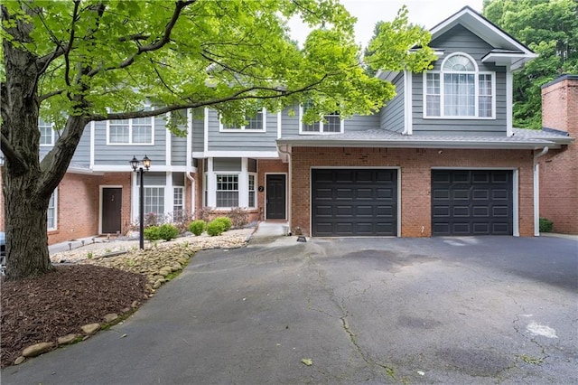 2680 Pine Tree Rd NE Unit 2, Atlanta, GA 30324 - townhome / multi-family property with brick siding, asphalt driveway, and an attached garage