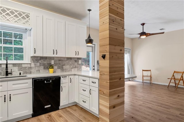 2680 Pine Tree Rd NE Unit 2, Atlanta, GA 30324 - kitchen featuring black dishwasher, light wood finished floors, backsplash, and light countertops