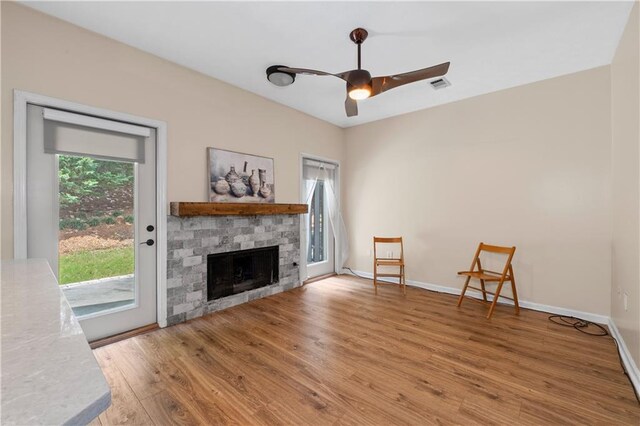 2680 Pine Tree Rd NE Unit 2, Atlanta, GA 30324 - unfurnished living room featuring light wood finished floors, a ceiling fan, and a fireplace
