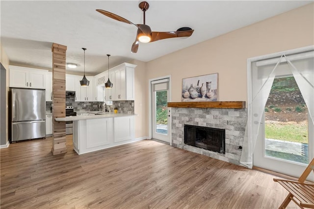 2680 Pine Tree Rd NE Unit 2, Atlanta, GA 30324 - kitchen featuring appliances with stainless steel finishes, light countertops, open floor plan, white cabinets, and tasteful backsplash