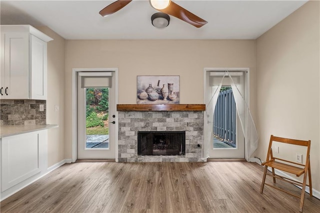 2680 Pine Tree Rd NE Unit 2, Atlanta, GA 30324 - unfurnished living room featuring healthy amount of natural light, ceiling fan, wood finished floors, and a fireplace