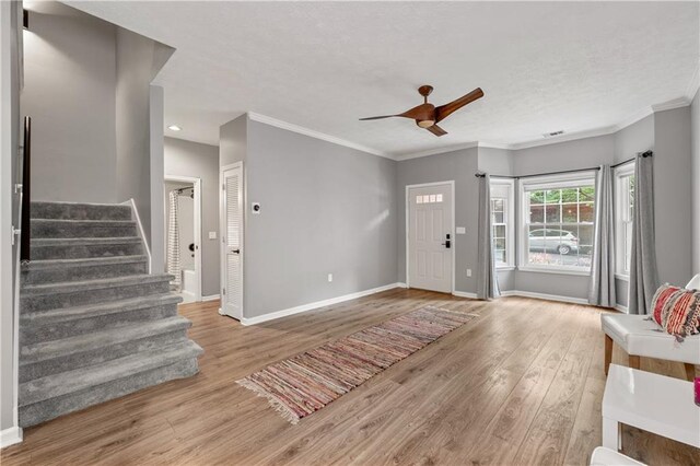 2680 Pine Tree Rd NE Unit 2, Atlanta, GA 30324 - entryway featuring stairs, wood finished floors, a ceiling fan, crown molding, and a textured ceiling