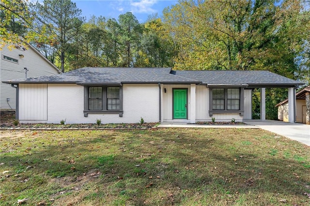 ranch-style house featuring a porch, a front yard, and a carport