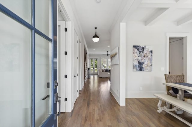 hallway featuring coffered ceiling, beam ceiling, dark hardwood / wood-style floors, ornamental molding, and french doors