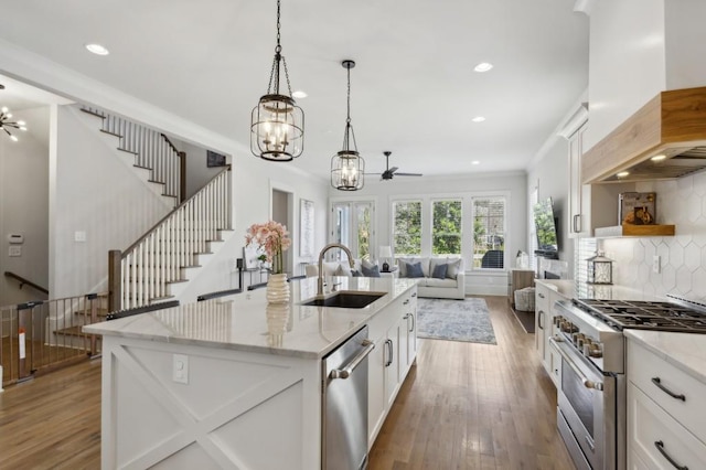 kitchen with pendant lighting, stainless steel appliances, custom exhaust hood, and white cabinetry