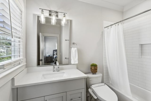 full bathroom featuring vanity with extensive cabinet space, shower / tub combo, and toilet