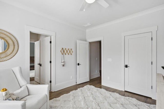 sitting room featuring crown molding, dark wood-type flooring, and ceiling fan