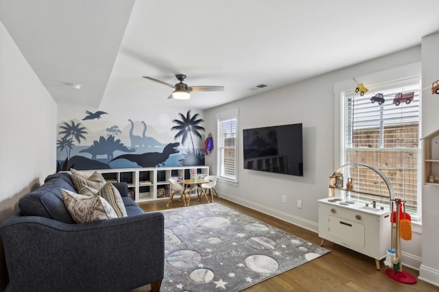 living room with ceiling fan and dark hardwood / wood-style floors