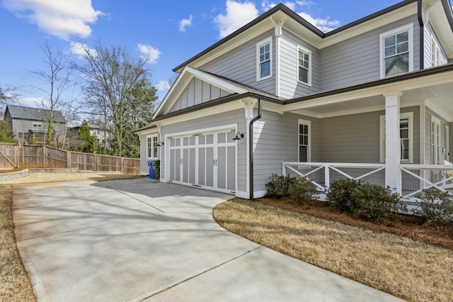 view of property exterior featuring a garage and covered porch