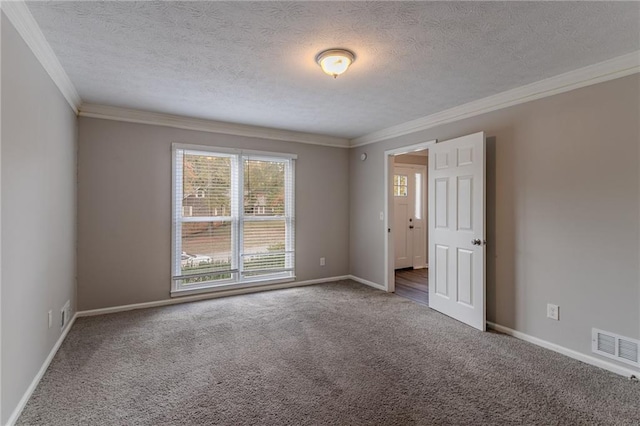 empty room featuring ornamental molding, carpet flooring, and a textured ceiling