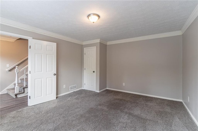 carpeted spare room featuring a textured ceiling and ornamental molding