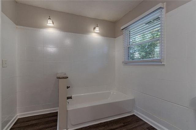 bathroom featuring hardwood / wood-style floors and a bathtub