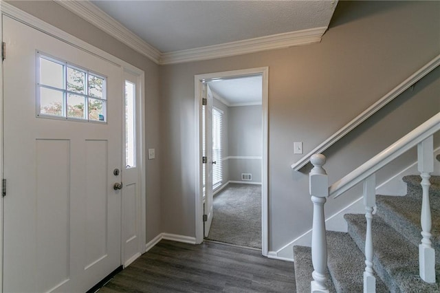 entryway with dark hardwood / wood-style floors and crown molding