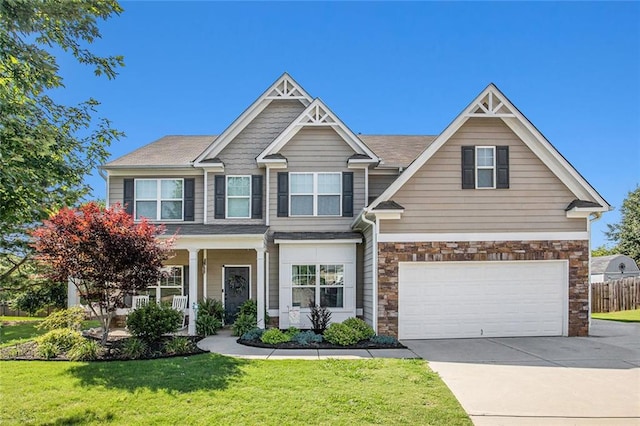 1329 Old Glory Ct, Hoschton, GA 30548 - craftsman inspired home featuring a garage, concrete driveway, stone siding, and a porch