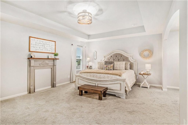 1329 Old Glory Ct, Hoschton, GA 30548 - carpeted bedroom featuring arched walkways and a tray ceiling