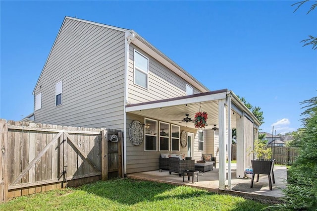 1329 Old Glory Ct, Hoschton, GA 30548 - rear view of house with ceiling fan, an outdoor living space, a fenced backyard, a patio, and a gate