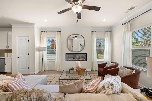 living room with light wood-type flooring and ornamental molding