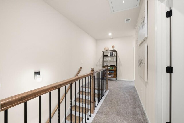 hallway featuring light colored carpet