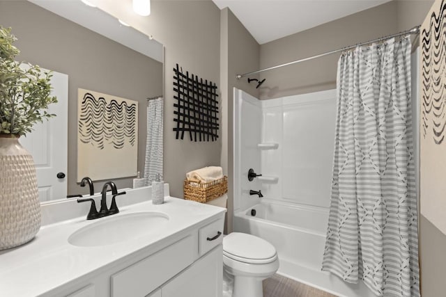 full bathroom featuring shower / bath combination with curtain, toilet, and vanity