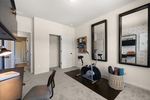 exercise room featuring light carpet