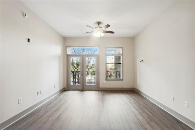 spare room with ceiling fan, french doors, and wood-type flooring