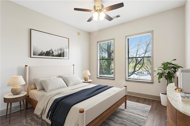 bedroom with ceiling fan and dark hardwood / wood-style floors