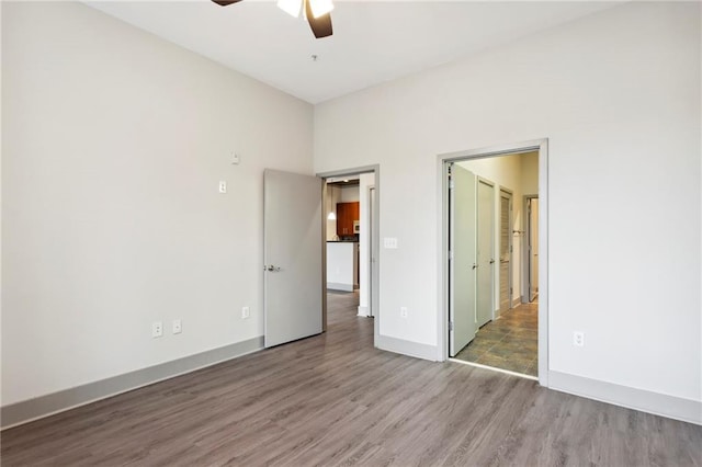 unfurnished bedroom with ceiling fan and hardwood / wood-style floors