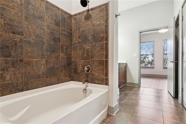 bathroom featuring tile patterned flooring, vanity, and washtub / shower combination