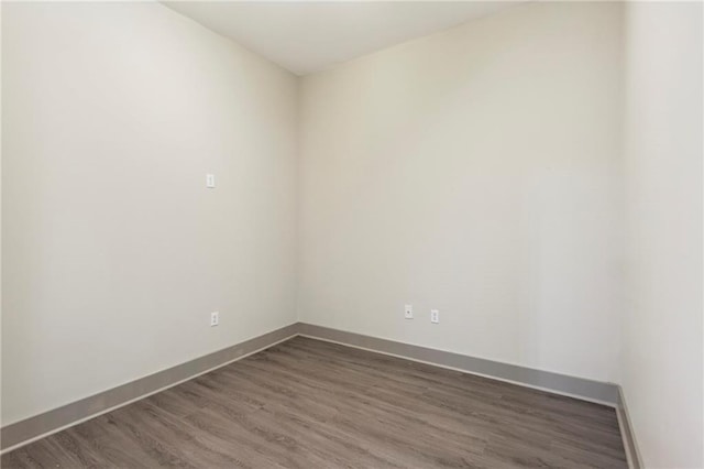 unfurnished room with dark hardwood / wood-style floors