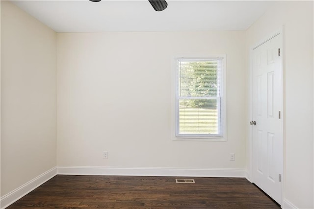 unfurnished room with dark wood-type flooring