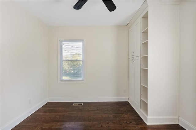 unfurnished room featuring dark hardwood / wood-style floors and ceiling fan