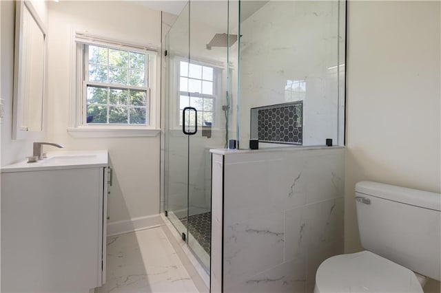 bathroom with vanity, a shower with shower door, and toilet