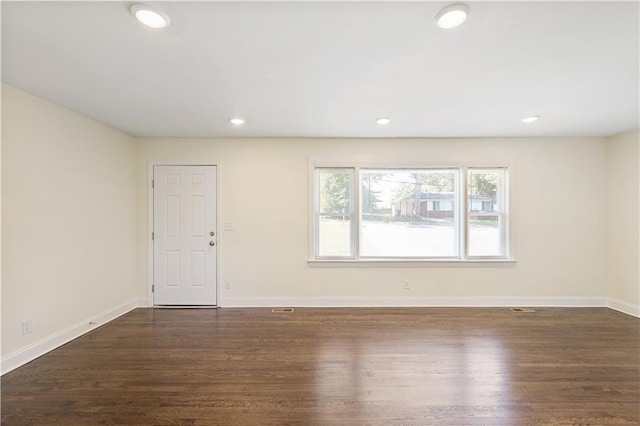 spare room featuring dark hardwood / wood-style flooring