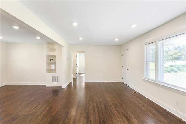 unfurnished living room featuring dark wood-type flooring