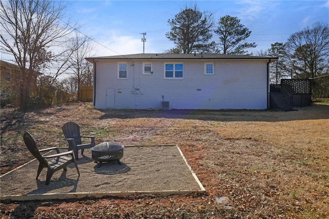 back of house with a fire pit