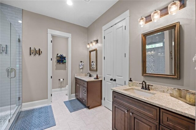 bathroom with vanity, tile patterned flooring, toilet, and an enclosed shower