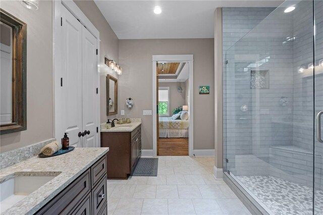 bathroom featuring vanity, tile patterned flooring, and an enclosed shower