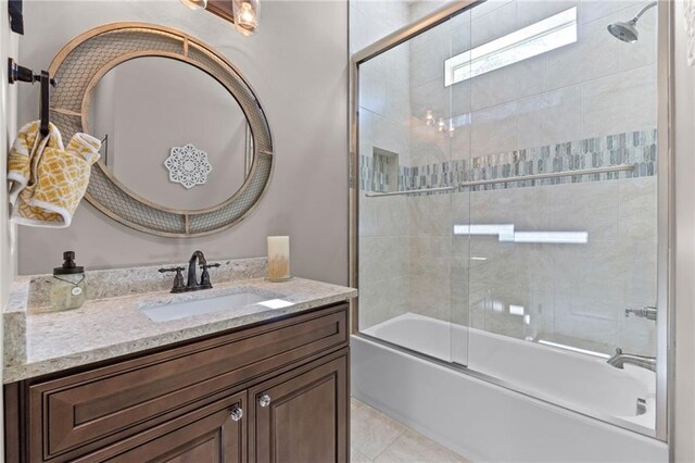 bathroom featuring vanity, combined bath / shower with glass door, and tile patterned floors