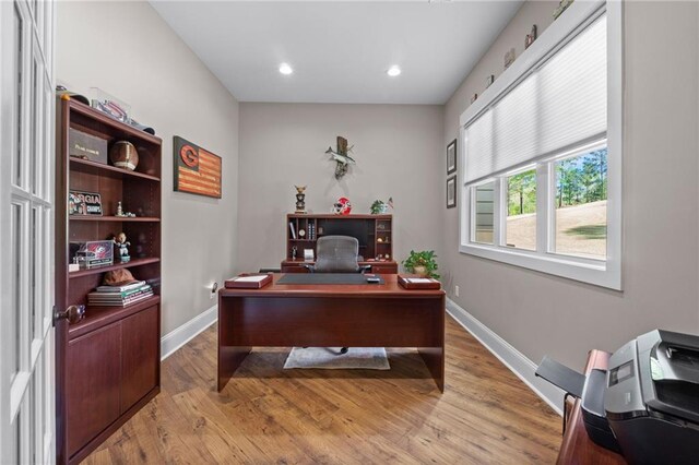 office area with light hardwood / wood-style floors