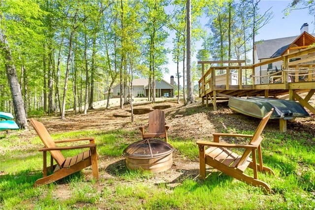 exterior space with an outdoor fire pit and a deck