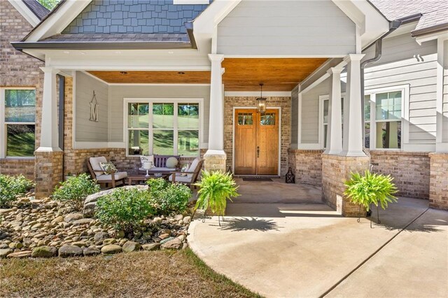 doorway to property featuring covered porch